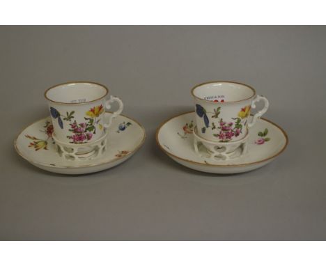 A pair of 18th century Vienna porcelain cups and trembleuse saucers,&nbsp;each painted with floral sprigs. 