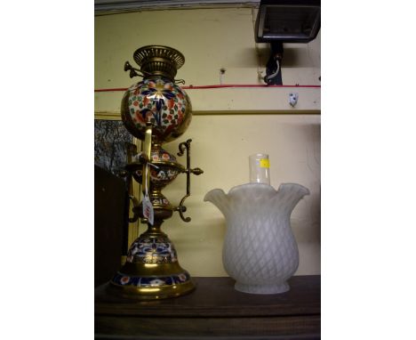 An Imari pottery and brass oil lamp,&nbsp;height including shade 63cm high.&nbsp; 