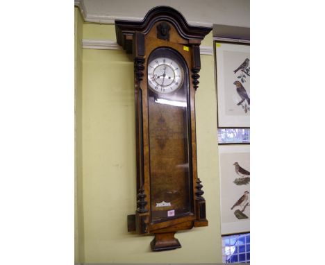 A late 19th century walnut and ebonized Vienna wall clock,&nbsp;with weight driven movement, the enamel dial with subsidiary 