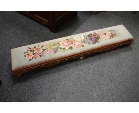A Victorian walnut and brass studded long hearth stool,&nbsp;125cm long.&nbsp; 