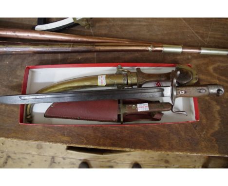 An unusual Japanese bayonet;&nbsp;together with a&nbsp;jambiya in brass sheath; and a Bowie type knife in leather scabbard. 
