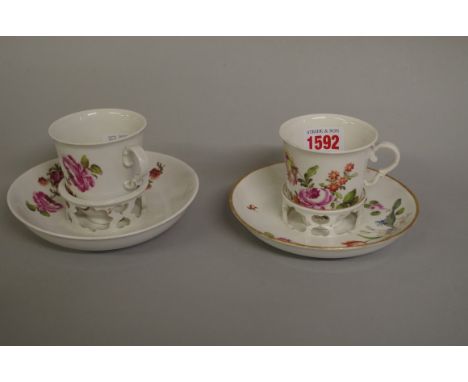 A pair of 18th century Vienna porcelain cups and trembleuse saucers,&nbsp;each painted with floral sprigs. 