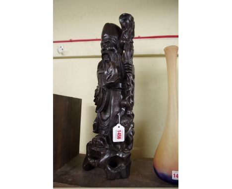 A large Chinese carved wood and metal wire inlaid figural lamp, 49cm high. 