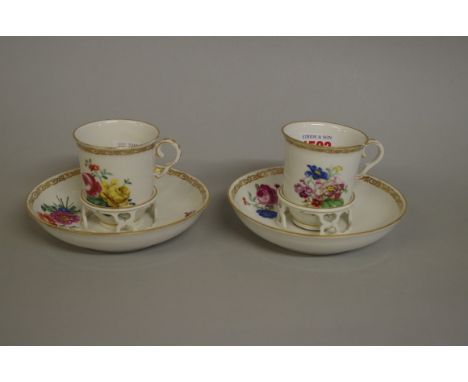 A pair of 18th century Vienna porcelain cups and trembleuse saucers,&nbsp;each painted with floral sprigs, (chip to rim of on