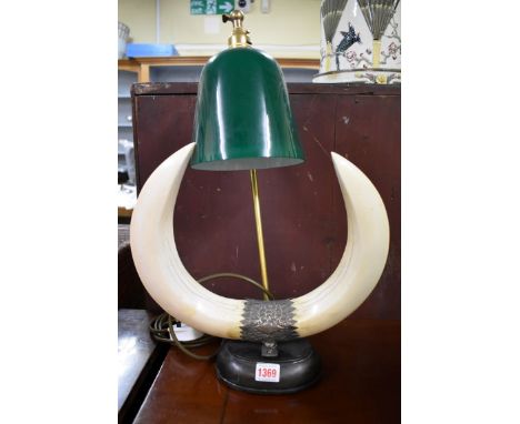 An Indian boar tusk and white metal mounted table lamp,&nbsp;50cm high.&nbsp; 