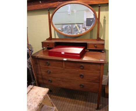 An early 20th-century dressing just oval bevelled mirror plate display shelf, with twin jewellery drawers over a base unit wi