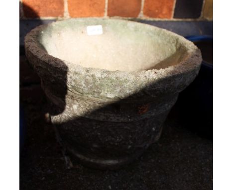 A cast concrete circular garden planter 