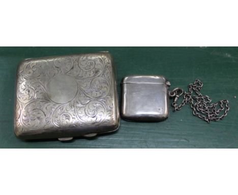 A hallmarked silver Vesta case, together with a chased metal cigarette case containing a religious medallion 