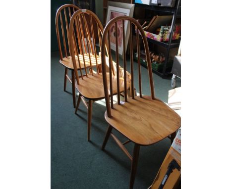 A trio of high hoop and stick back to solid seated chairs 