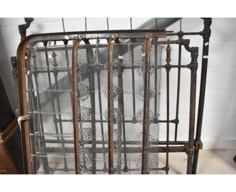 A vintage cast iron bed frame and sprung base