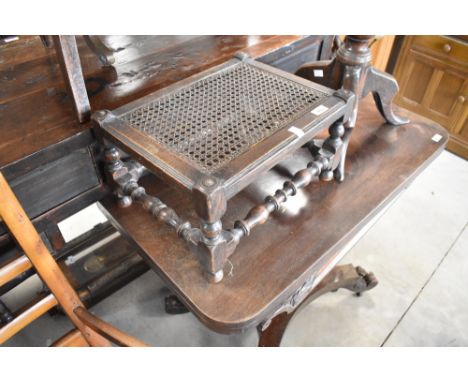 A traditional cane seated footstool, width approx. 41cm