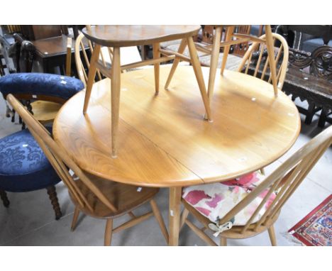 A traditional Ercol light stain drop leaf dining table and six hoop and stick back dining chairs