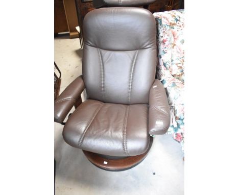 A dark brown leather Stressless easy chair and footstool