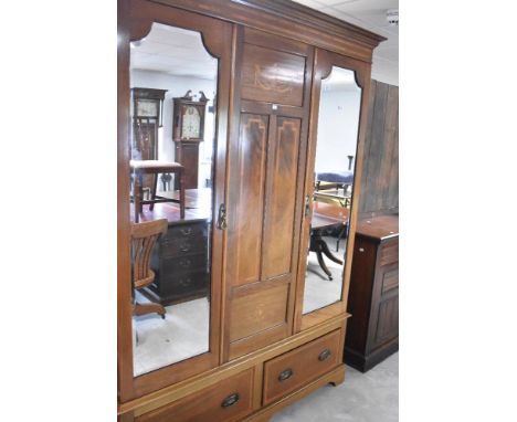 An Edwardian mahogany mirror and double door wardrobe