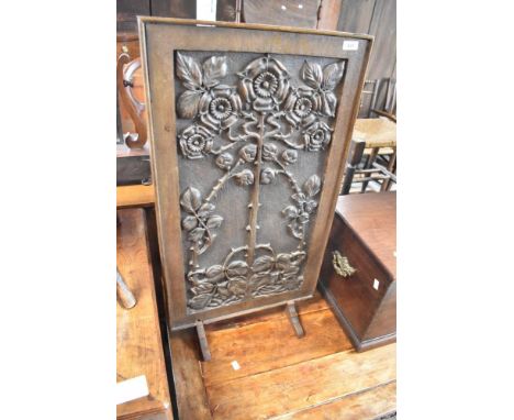 A traditional fire screen having carved foliate panel. Approx width 46cm