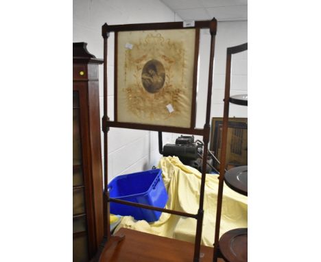 A fine Edwardian mahogany fire screen having pictorial silk inset