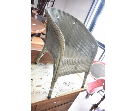 A vintage Lloyd Loom tub chair in green