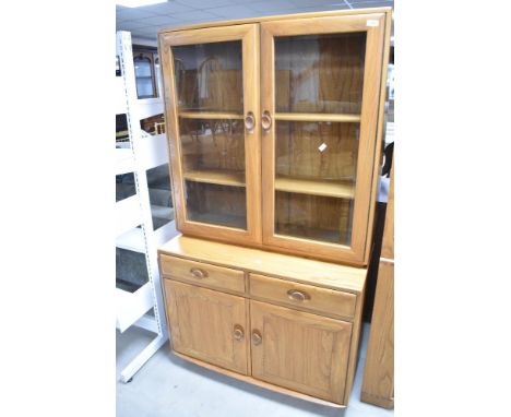 An Ercol 'golden dawn' style bookcase having cupboard under, width approx. 91cm