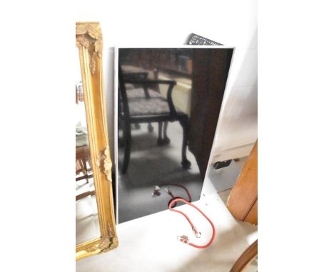 A Panasonic flatscreen TV , with separate stand