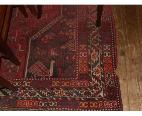 A Shiraz carpet, decorated with geometric motifs, on a red ground, within a multi border, 316 x 226 cm