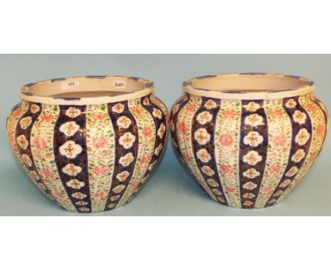 A pair of Chinese jardinieres, of lobed circular form, decorated panels of foliage in enamel colours, 29 cm diameter (2) Cond
