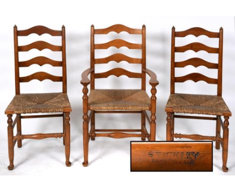 A set of four Stickley ladder back dining chairs, with rush seats, marked Stickley, Fayetteville, Syracuse, and a matching pa