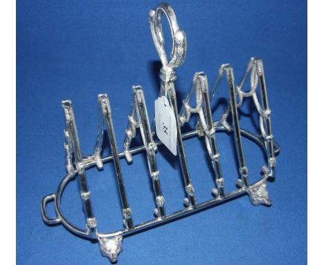 A plated fox hunting toast rack, decorated riding crops