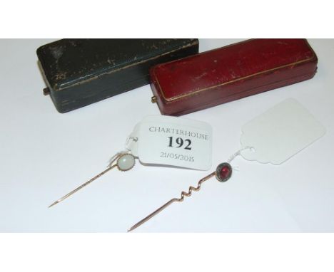 A 9ct gold, garnet and diamond stick pin, and another stick pin, both cased (2)