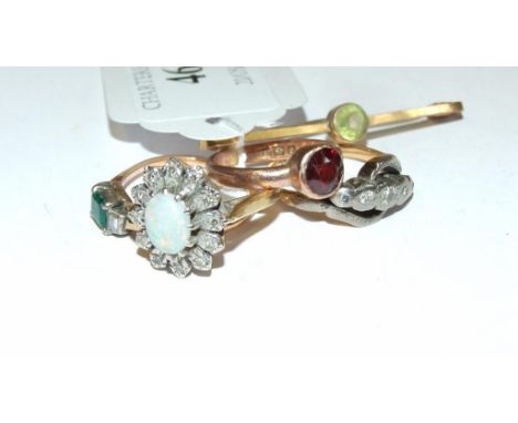 An 18ct gold, opal and diamond flowerhead ring, two other rings, and a bar brooch