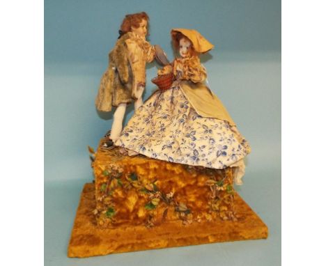 An automaton, of a couple, on a platform base, 36 cm wide