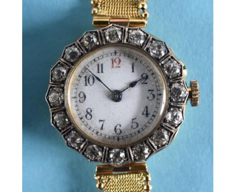A lady's 18ct gold wristwatch, the white enamel dial with Arabic numerals within a diamond bezel, set 16 old brilliant cut st