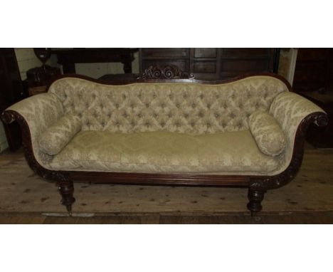 An early Victorian mahogany scroll end settee, with an upholstered button back, and leaf carved decoration, on turned feet, 2