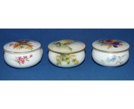 A Royal Worcester porcelain box and cover, decorated a chaffinch, 6.5 cm diameter (a.f.), and two others (3)