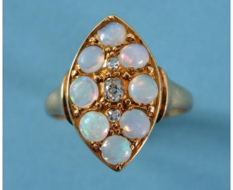 A diamond and opal ring, in a yellow coloured metal marquise setting  See illustration