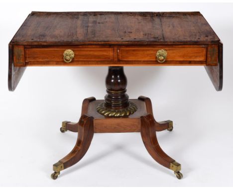 A Regency rosewood sofa table, inlaid with brass, having two real and two false drawers, on a baluster turned column, platfor