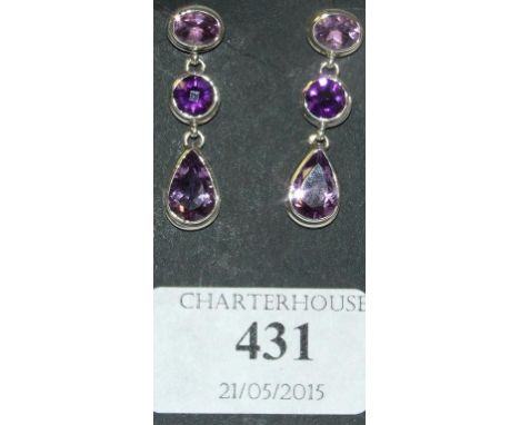 A pair of silver and amethyst drop earrings