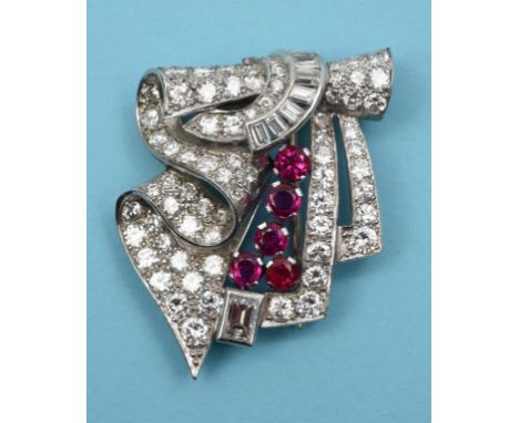 An Art Deco style diamond and ruby clip brooch  See front cover colour illustration
