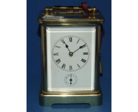 A carriage timepiece, with alarm, the enamel dial having Roman numerals and subsidiary dial, in a four pillar brass case, 13 