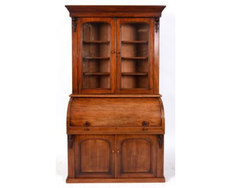 A Victorian mahogany cylinder bookcase, having a pair of glazed doors above a cylinder section with a pair of arched panel do