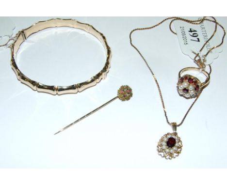 A 9ct gold bamboo bangle, approx. 10.4 g, a 9ct gold, seed pearl and garnet ring, a similar pendant on chain, and a stick pin