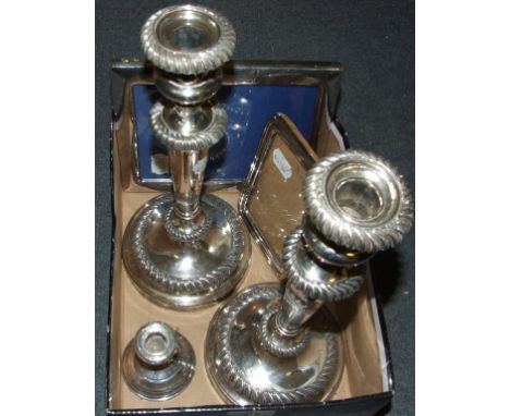 A silver strut photograph frame, Birmingham 1919, 16 cm high, a silver dwarf candlestick, a silver plated strut photograph fr