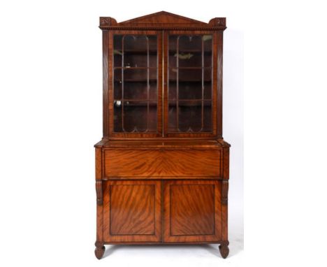 A Regency mahogany secretaire bookcase, the architectural cornice above a pair of bar glaze doors, with a secretaire drawer a