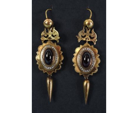 A pair of Victorian yellow coloured metal, enamel and cabochon garnet drop earrings  See inside back cover colour illustratio
