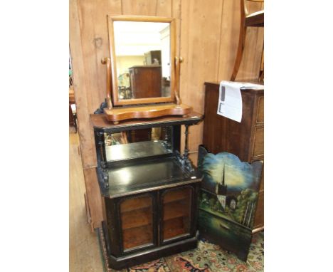 A Victorian ebonised cabinet, 66 cm wide, a dressing mirror, a wall mirror, a fire screen decorated a church, two inlaid rose