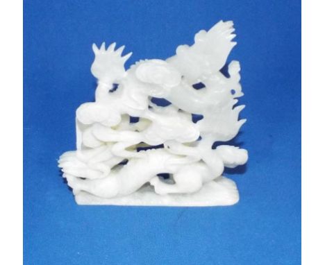 A Chinese carved jade group, of dragons chasing a flaming pearl (minor chips), 11 cm high