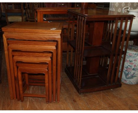 A reproduction revolving bookcase, 49 cm wide, a nest of four occasional tables, a table vitrine, and other occasional furnit