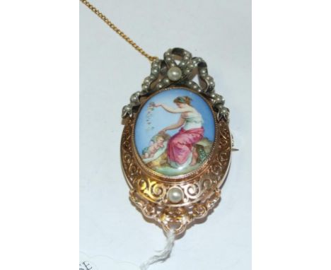 A yellow coloured metal and enamel brooch, decorated a mother and child, under a ribbon tie set seed pearls