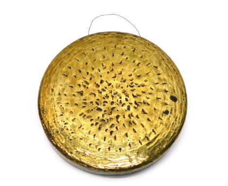 A polished bronze gong, 40cm diameter. 