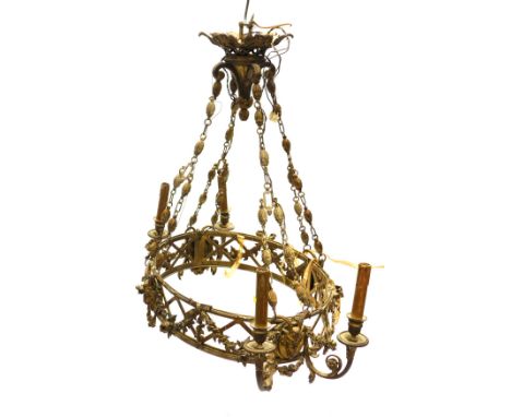 An unusual Continental gilt metal light fitting, of oval form with two pairs of candle arms to each ends, supported by leaf c