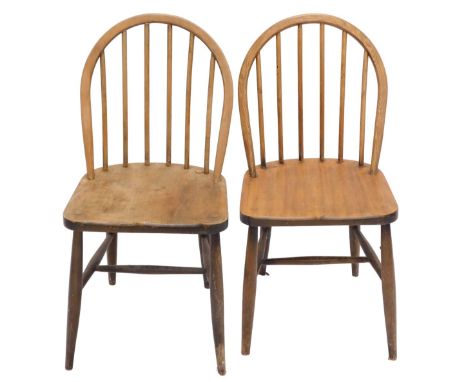 A pair of mid 20thC stickback kitchen chairs, in Ercol style, with a solid seat, on turned legs.